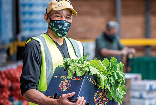 A Massmart associate unloads boxes of fresh produce