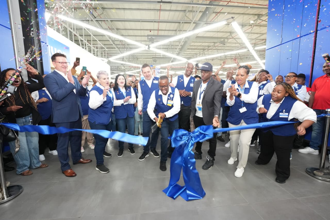 A group of employees and guests gather for a ribbon cutting ceremony inside the new Walmart store in Boksburg.